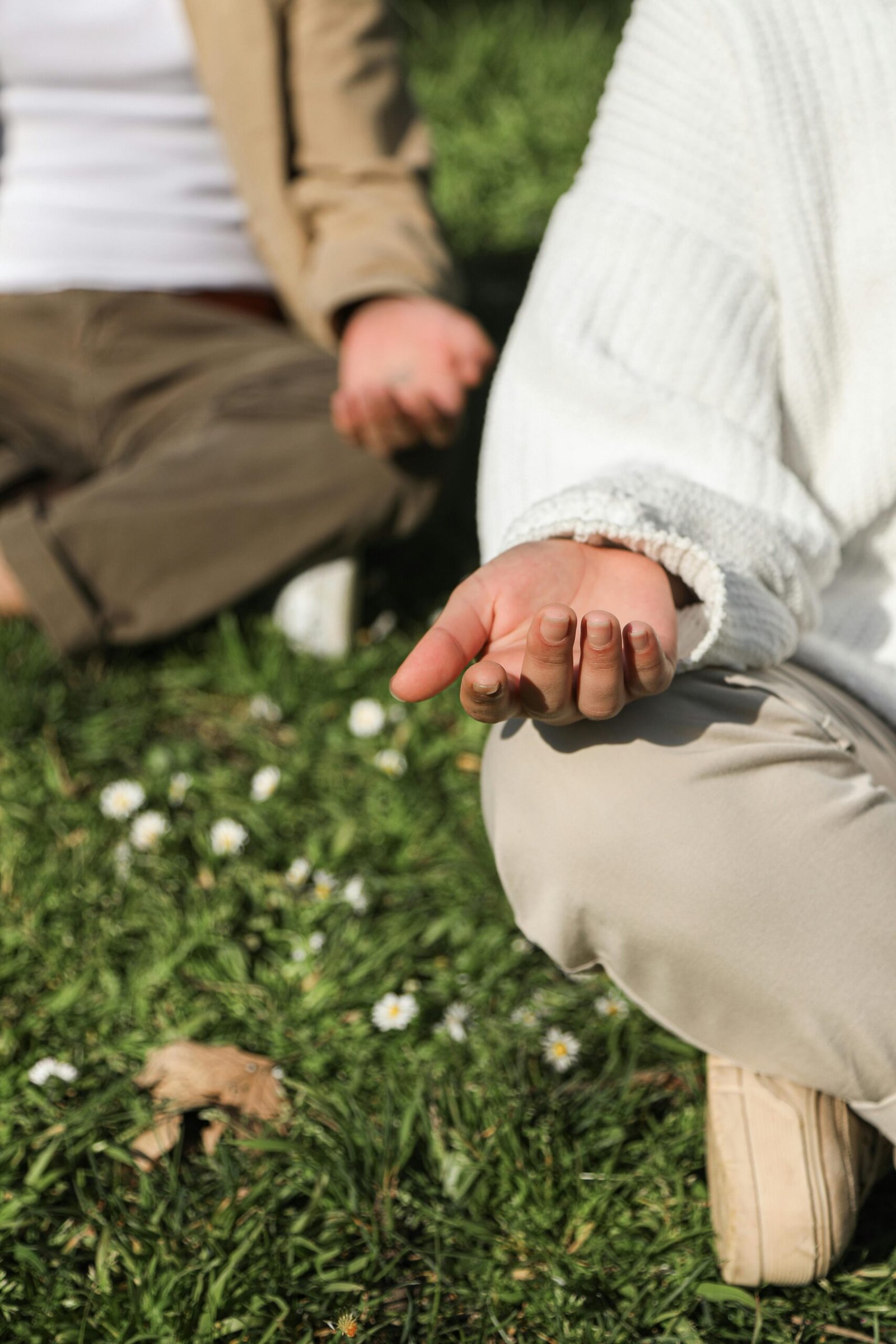 Peaceful outdoor meditation scene emphasizing relaxed hands and nature.